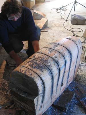 cutting a lead keel with a chainsaw