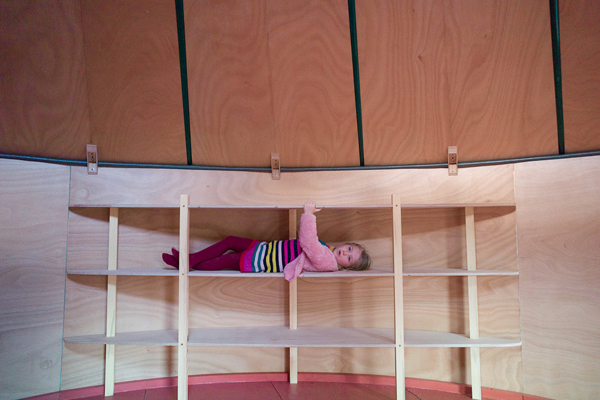 child on shelf
